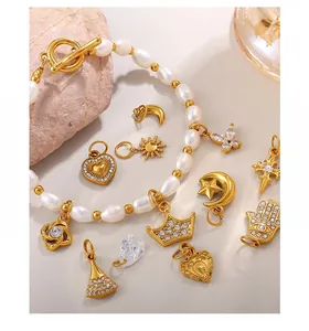 Detailed set of irregular pearls with gold-plated charms like crowns and hearts