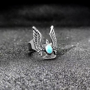 Macro shot of vintage eagle ring with turquoise stone and detailed silver feathers