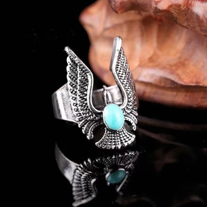 Vintage eagle ring with turquoise gemstone in retro punk style for men on wood base
