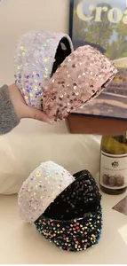 Macro shot of stylish sequin headbands in iridescent white, rose gold, and black colors