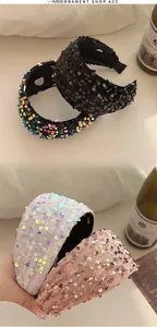 Detail of four wide sequin headbands in black, white, rose gold and iridescent colors