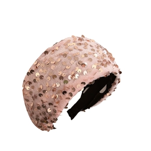 Pink padded headband with rose gold sequins for a high top hairstyle fashion look