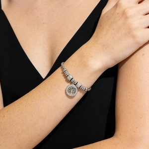 Silver Tree of Life beaded bracelet with micro-pave crystals on a female wrist