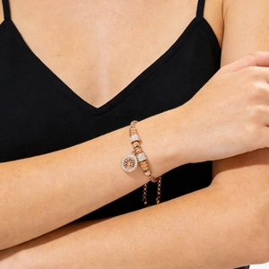 Detail of rose gold Tree of Life bracelet with pavé-set crystal beads on a model's wrist