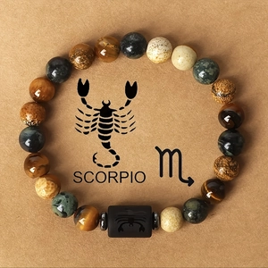 Scorpio beaded bracelet featuring natural tiger eye stones and a black engraved zodiac bead