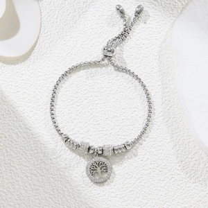 Macro view of adjustable Tree of Life bracelet with pavé rhinestones on white texture