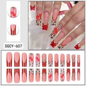 Long coffin fake nails with red French tips, leopard print, and 3D cherry charm stones
