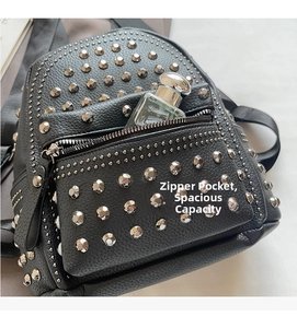 Detailed view of the front zipper pocket with silver studs and capacity for perfume