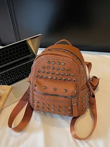 Vintage brown rivet leather backpack for women with stylish punk studs and front pocket