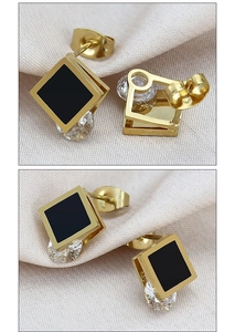 Macro detail of square black lacquer stud earrings with round cubic zirconia and gold plating