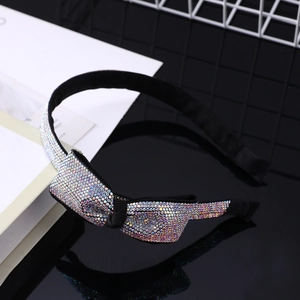 Dettaglio di un cerchietto di lusso con strass colorati e design a forma di fiocco
