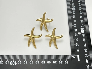 Top view of gold starfish ring measuring 30mm with size reference on white background