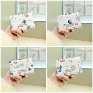 Detailed grid view of three-fold floral mini wallets with metal clasp and pink label