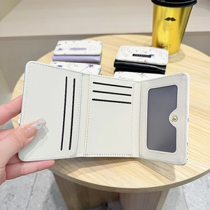 Detail view showing internal five card slots and one photo window of floral tri-fold wallet
