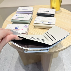 Detailed interior of tri-fold floral wallet showing multiple card slots and cash pocket