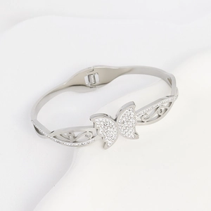 Polished titanium steel butterfly bangle with micro-set diamonds on white display