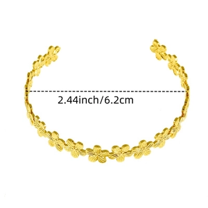 Detail view of a gold flower cuff bracelet with fine petal engraving and 6.2cm diameter