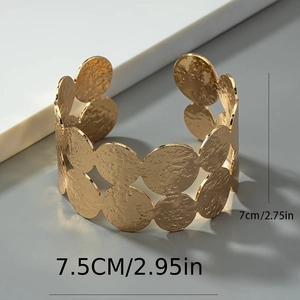 Detailed view of wide hammered gold cuff bracelet showing 7cm height dimensions