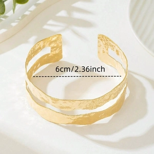 Macro shot of wide gold hammered cuff bracelet showing 6cm or 2.36 inch inner diameter
