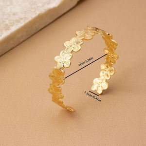 Golden flower open cuff bracelet with textured floral pattern and dimensions displayed