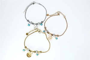 Close-up of evil eye bracelets in gold, silver, and rose gold with turquoise beads