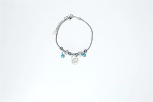 Macro view of silver stainless steel evil eye charm bracelet with turquoise beads