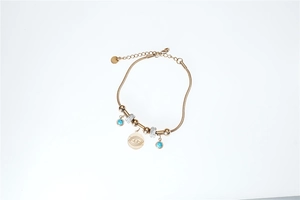 Detail of gold evil eye bracelet with blue stones and sparkling pavé crystal beads