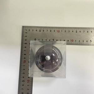 Purple service bell in plastic box showing dimensions measured by a metal ruler
