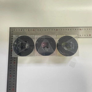Top view of three black service bells in clear packaging with a size measuring scale
