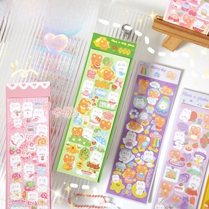 Close-up of cute cartoon laser stickers with bear and rabbit patterns for DIY decor