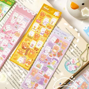 Close-up of cute cartoon bear and bunny laser stickers on a book for DIY journals