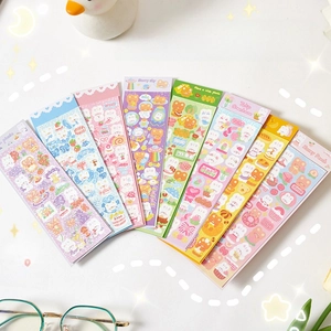 Close-up of cute laser laser stickers with cartoon bears and flowers for DIY journals