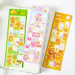 Detailed view of laser sparkling cute bear and floral DIY scrapbooking stickers on a notebook