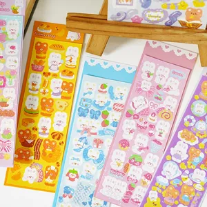 Detailed close-up of cute DIY laser stickers with bear and bunny motifs for scrapbooks
