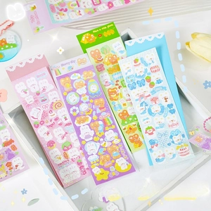 Detail of holographic laser DIY stickers with cute bear and rabbit patterns on a tray