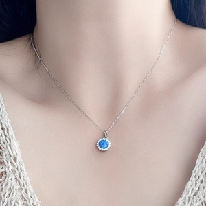 Elegant S925 sterling silver necklace featuring a round blue opal pendant with zircon halo
