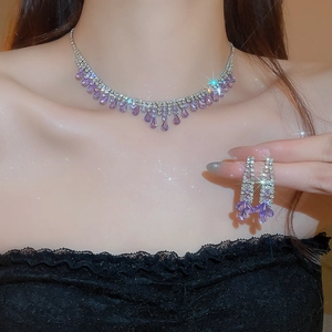 Close-up of purple zircon tassel necklace and earrings set with silver-tone plating