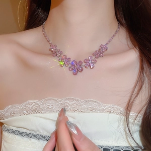 Close-up of elegant pink zircon flower pendant necklace worn on female neck