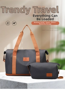 Deep grey waterproof travel bag set with orange handles and brown leather logo detail