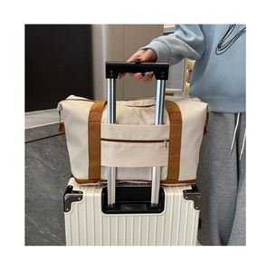 Detail of travel bag trolley sleeve sliding over luggage handle for easy transport