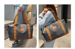 Detail showing reinforced wide straps and durable double-layer design on gray travel bag