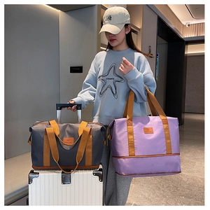 Detail view of large travel tote bags in grey and purple with luggage handle sleeve feature