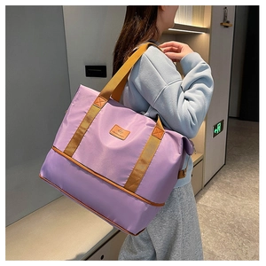 Detail of purple nylon travel bag showing leather reinforcement and logo patch
