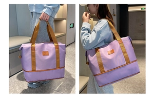 Lifestyle shot of model carrying the large purple waterproof travel duffel bag