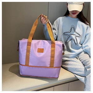 Purple waterproof nylon travel bag shown on a model, ideal for gym and sport weekend trips