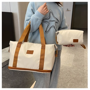 Detail of travel bag set featuring a wet-dry bottom compartment and a matching pouch