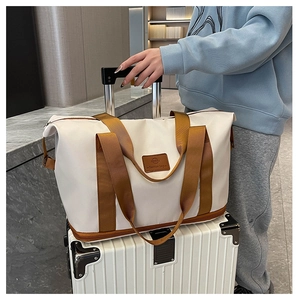 Detail view of large travel bag with wet-dry bottom compartment on a suitcase