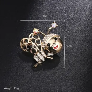 Detailed macro shot of honey bee brooch with crystal wings and golden alloy finish