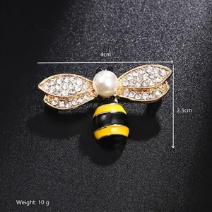 Detail shot of a small bee brooch with dimensions 4cm by 2.5cm on a black background
