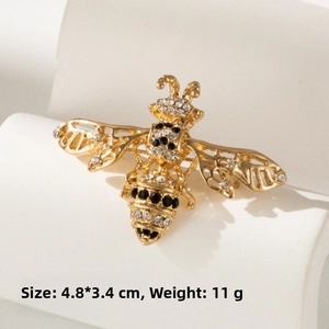 Close-up of golden bee brooch with rhinestones showing dimensions 4.8x3.4cm